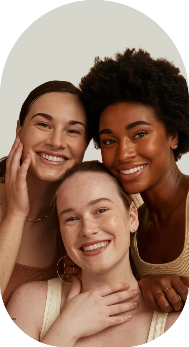 Three women of different backgrounds smiling together