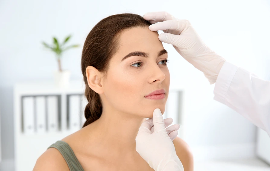 woman getting her skin assessed for microneedling