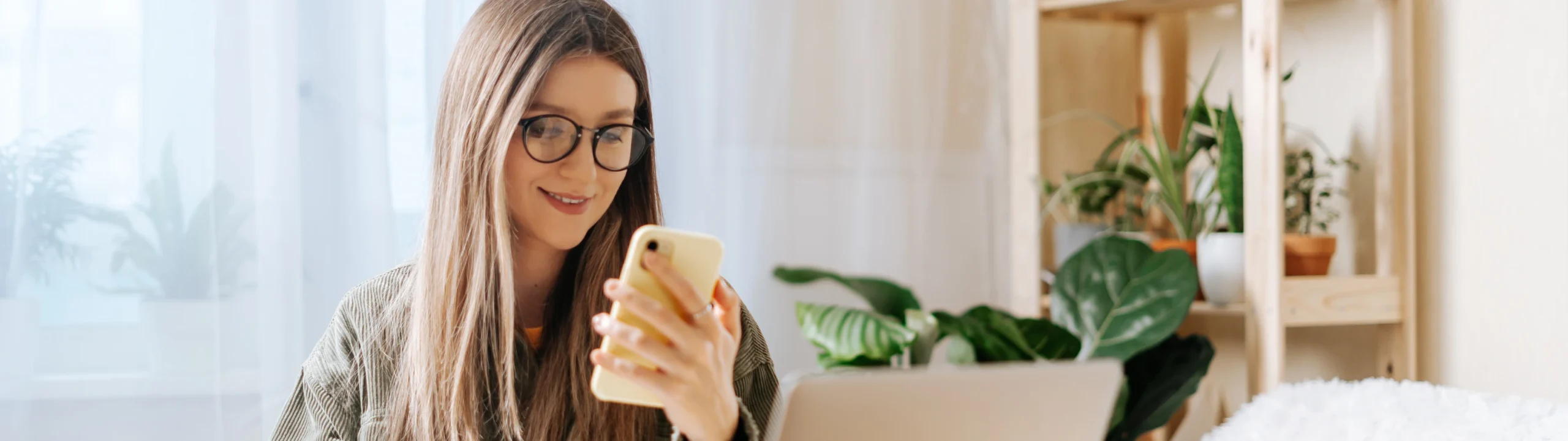 Smiling woman at home looking at Beautifi on her phone