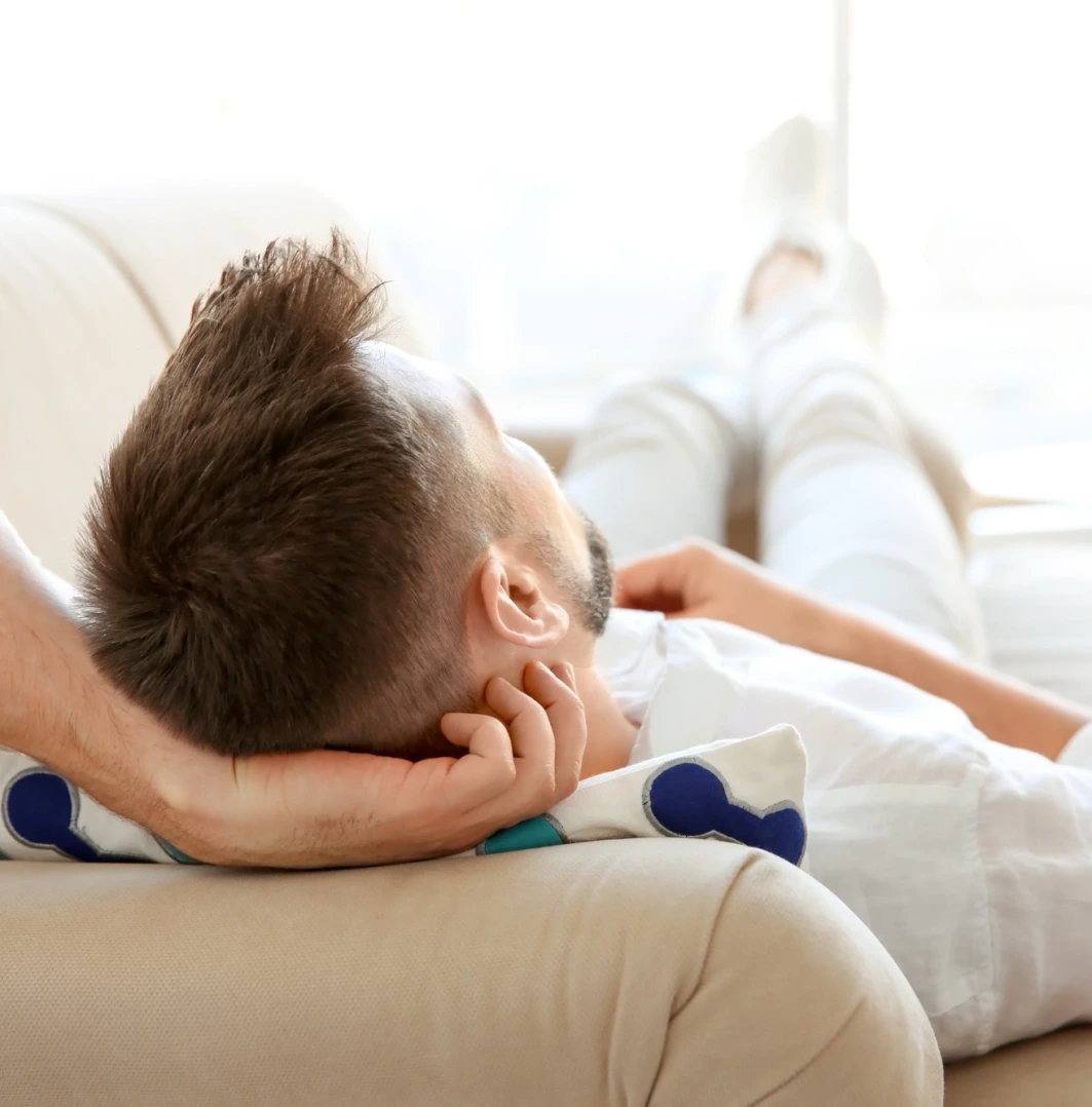 man laying down at home on the couch