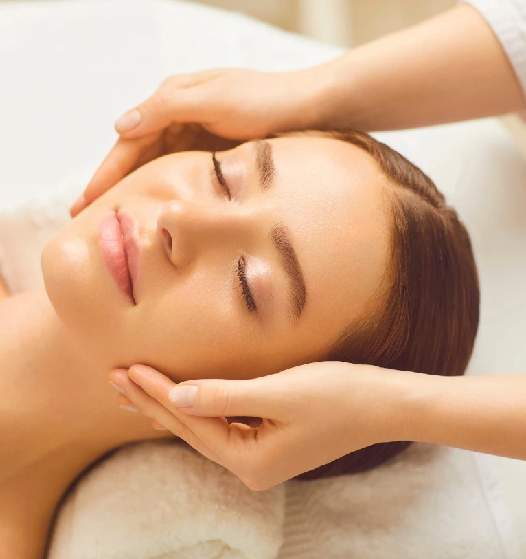 woman smiling getting a medical facial treatment