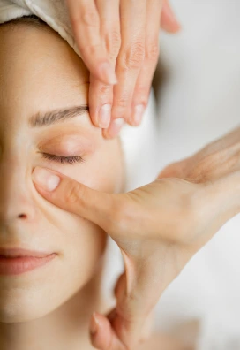 woman getting a relaxing face massage and facial