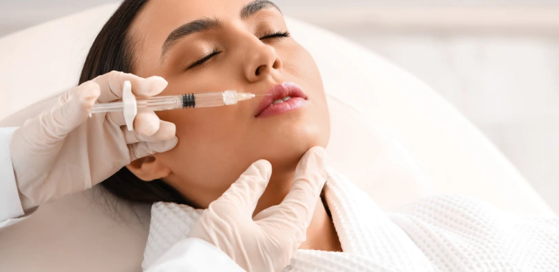 young woman at skin clinic getting lip filler injectables