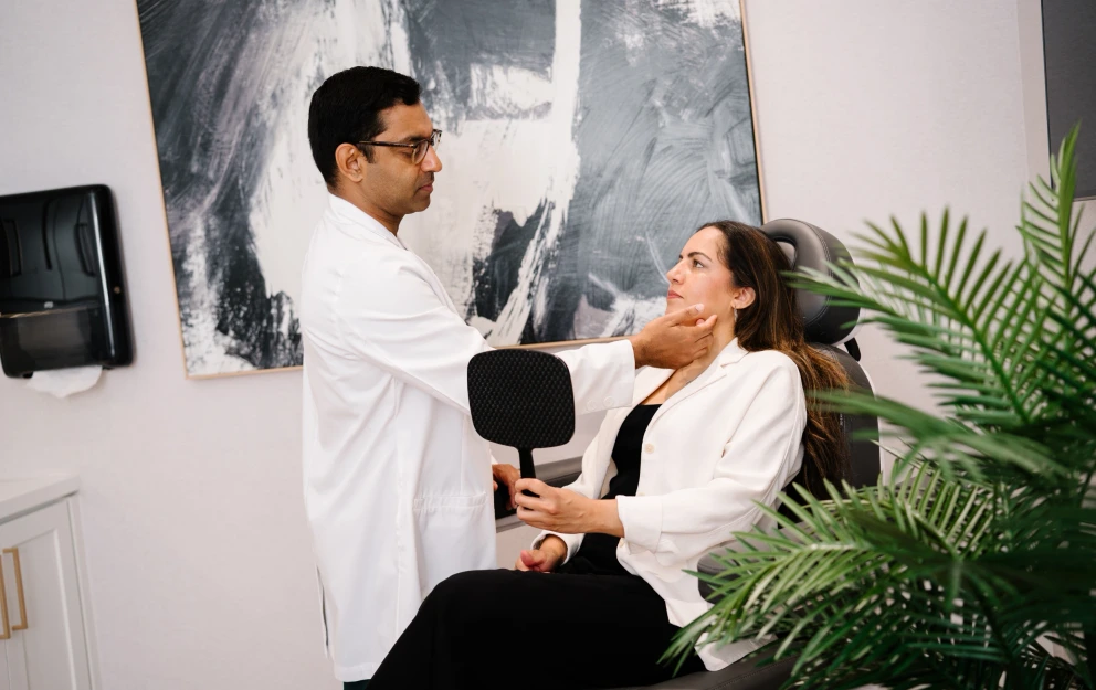 Cosmetic Surgeon performing a medical aesthetics consultation